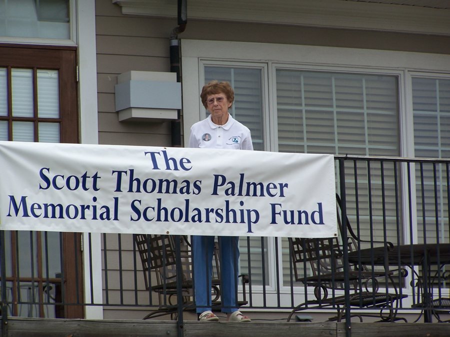 A banner reading The Scott Thomas Palmer Memorial Scholarship Fund at a golf tournament check-in.